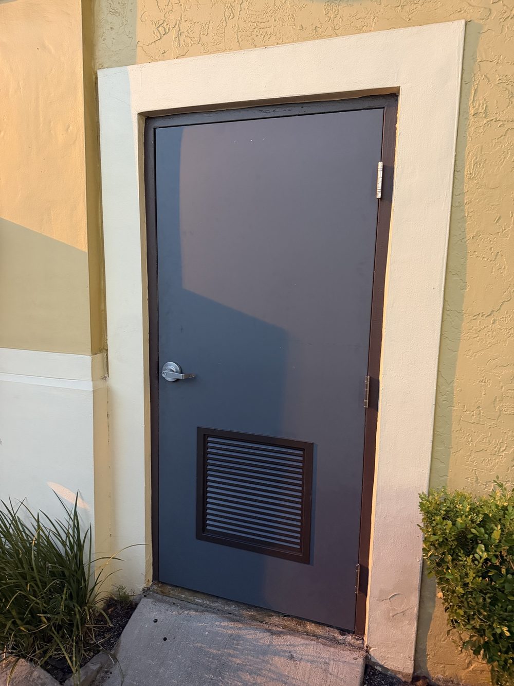 New gray fire-rated metal door after replacement
