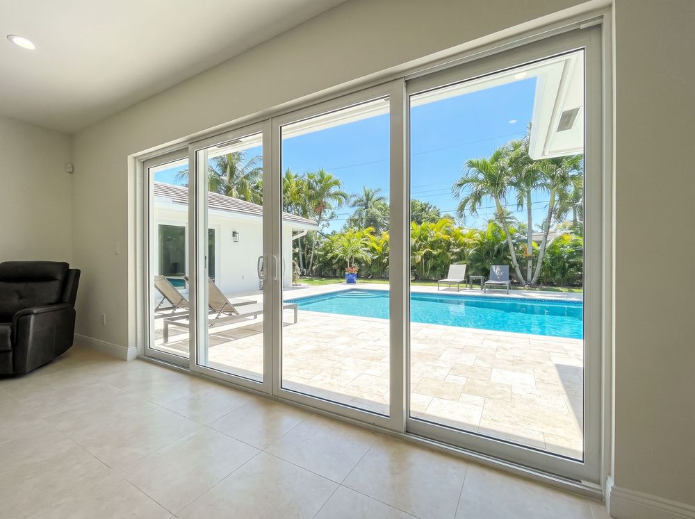 The same sliding glass door wall after repair, with the track straightened, new rollers installed and the panel running true