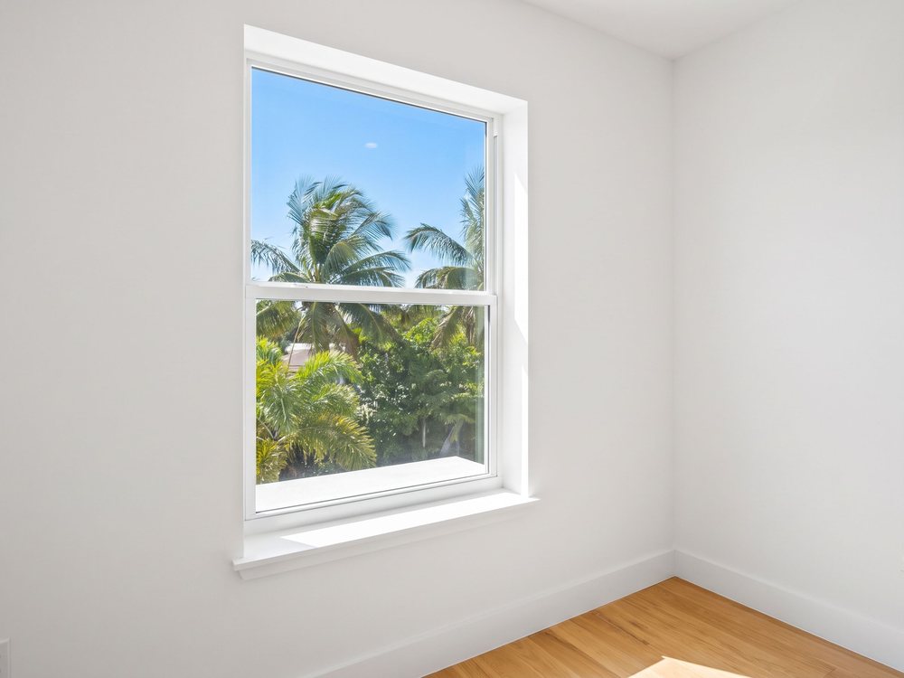 The same window after repair, with a new intact glass pane installed in the original frame