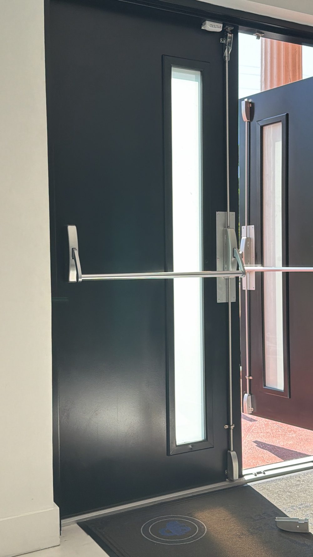 Newly installed panic bars on commercial double doors