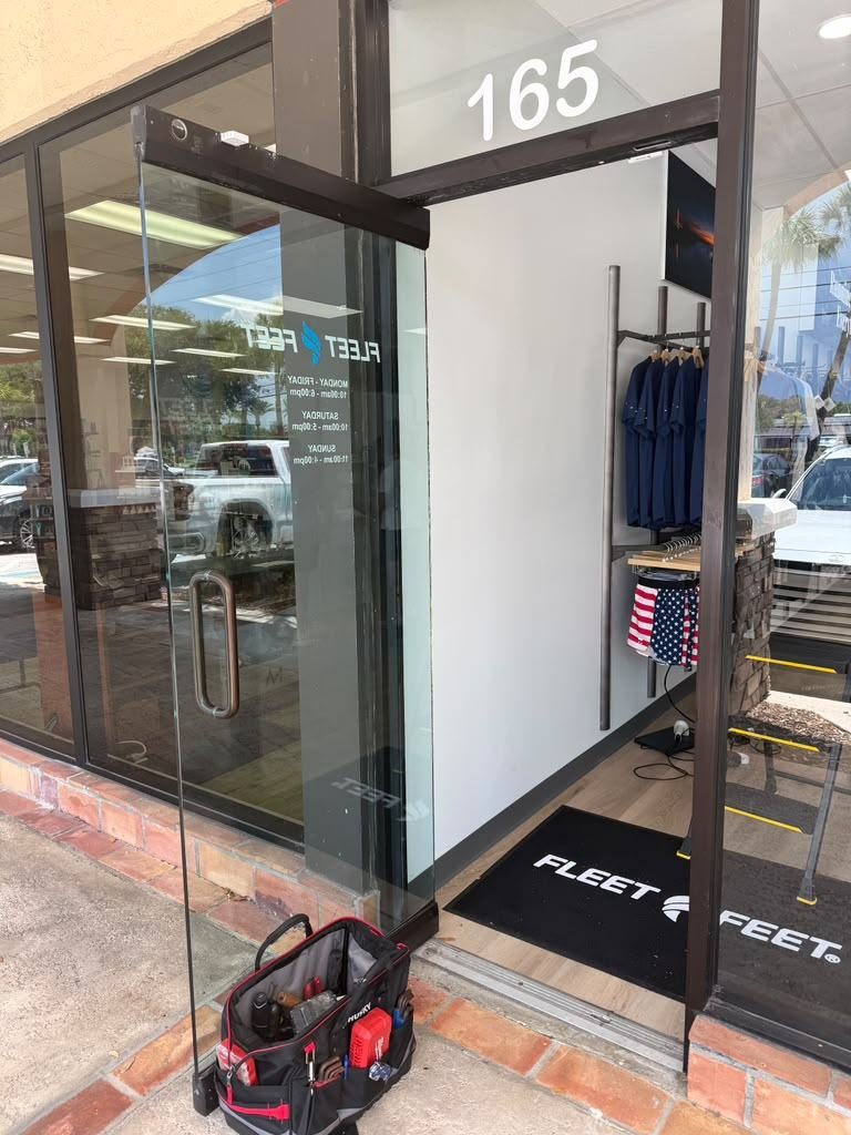 Commercial storefront entry door with a surface-mounted closer
