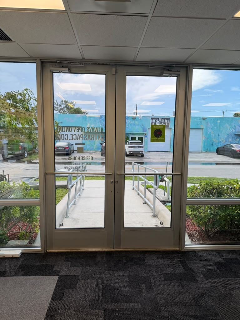 Glass double storefront entry doors with push bars