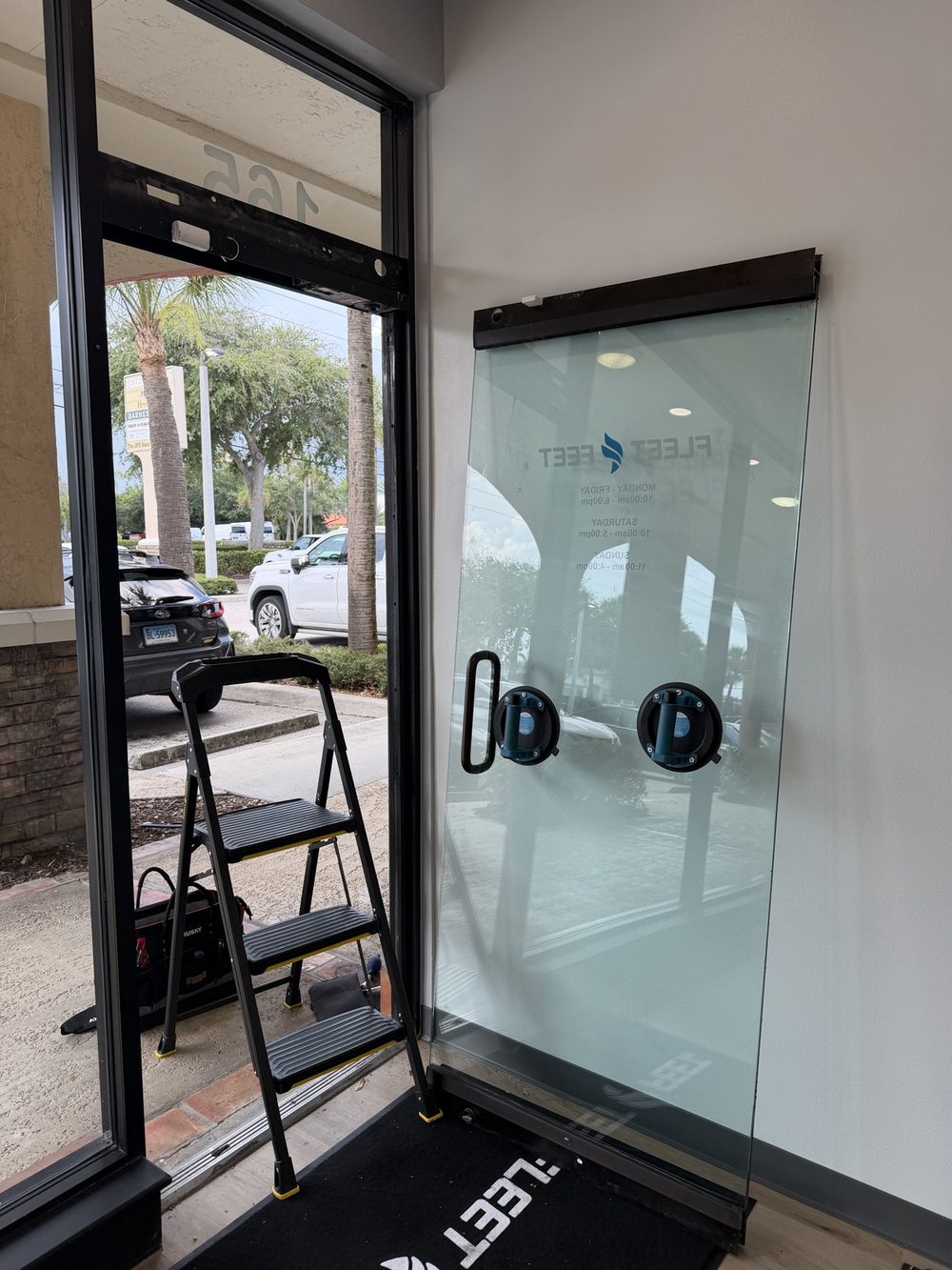 Storefront glass door removed for hardware service